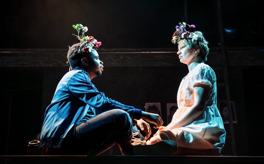 Two people siting cross legged, looking at each other. The photo was taken from CPT's production of Wuthering Heights.