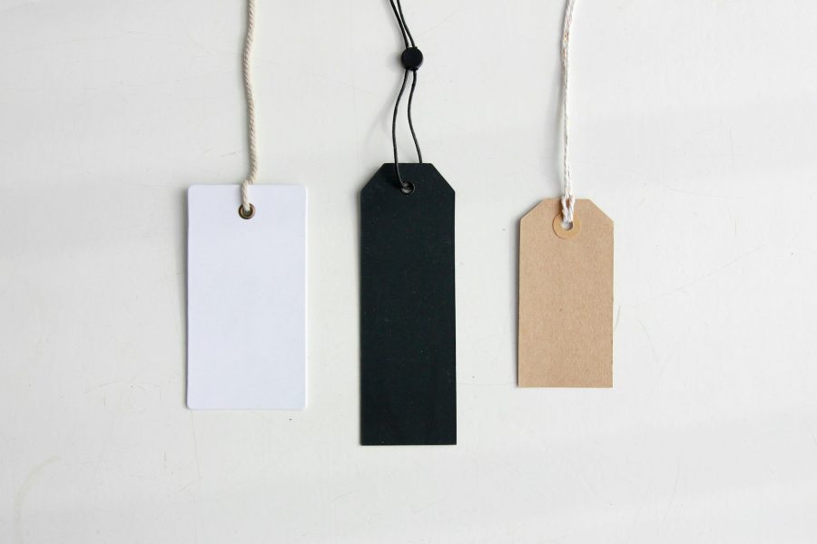 Different coloured gift tags against an off-white background