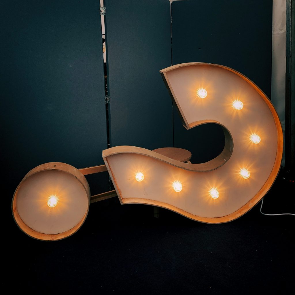 A white question mark shaped light on its side