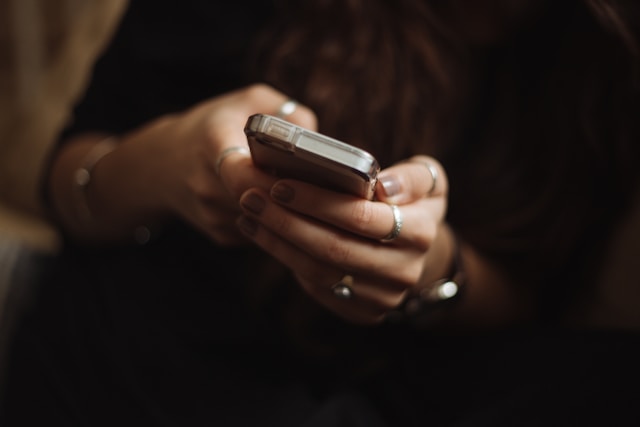 A person holding their mobile phone