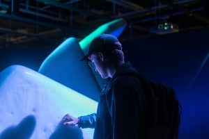 A young person touching an art installation in Canada