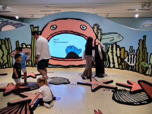 Children and adults experiencing an exhibition