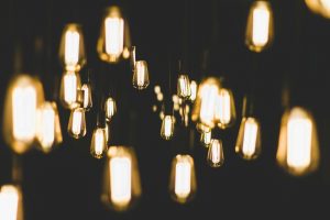 Photo of a collection of yellow light bulbs against a dark background