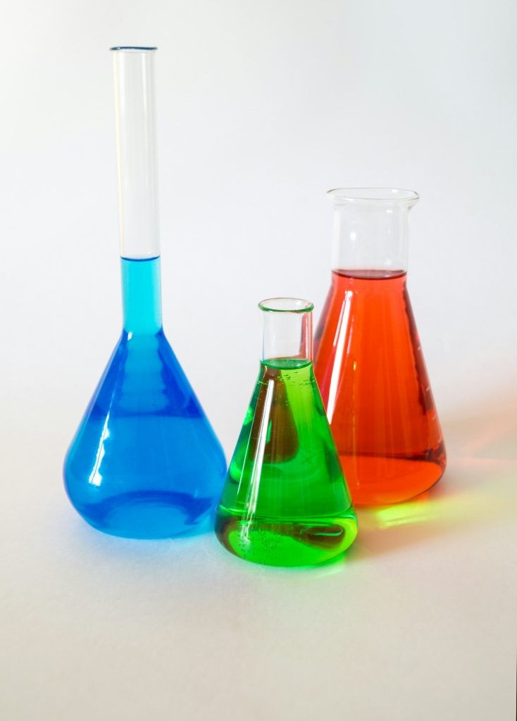 Conical flasks with different coloured liquid